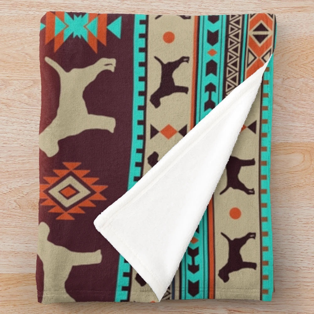 Border Terrier dog breed on a plush boho-style blanket with sunset colors