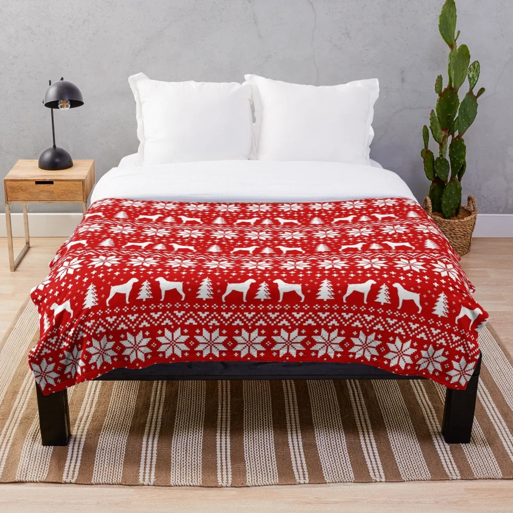 Boxer dog silhouettes in a festive red and white Christmas pattern on a plush blanket