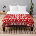 Boxer dog silhouettes in a festive red and white Christmas pattern on a plush blanket