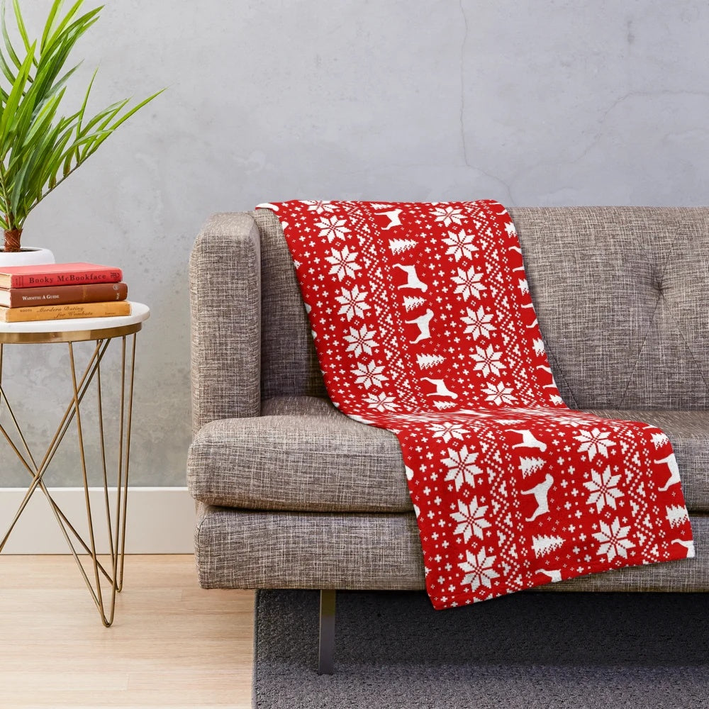 Boxer dog silhouettes in a festive red and white Christmas pattern on a plush blanket