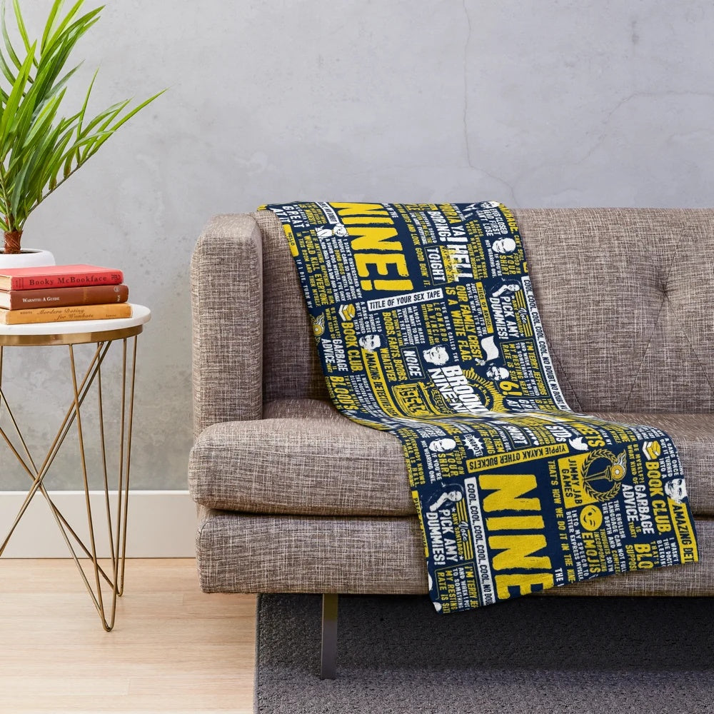Brooklyn Nine-Nine inspired plush blanket with Nine-Nine logo and characters