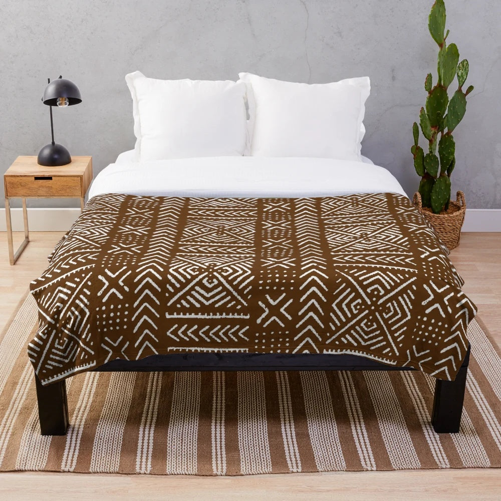 Brown plush blanket with intricate African mud cloth design