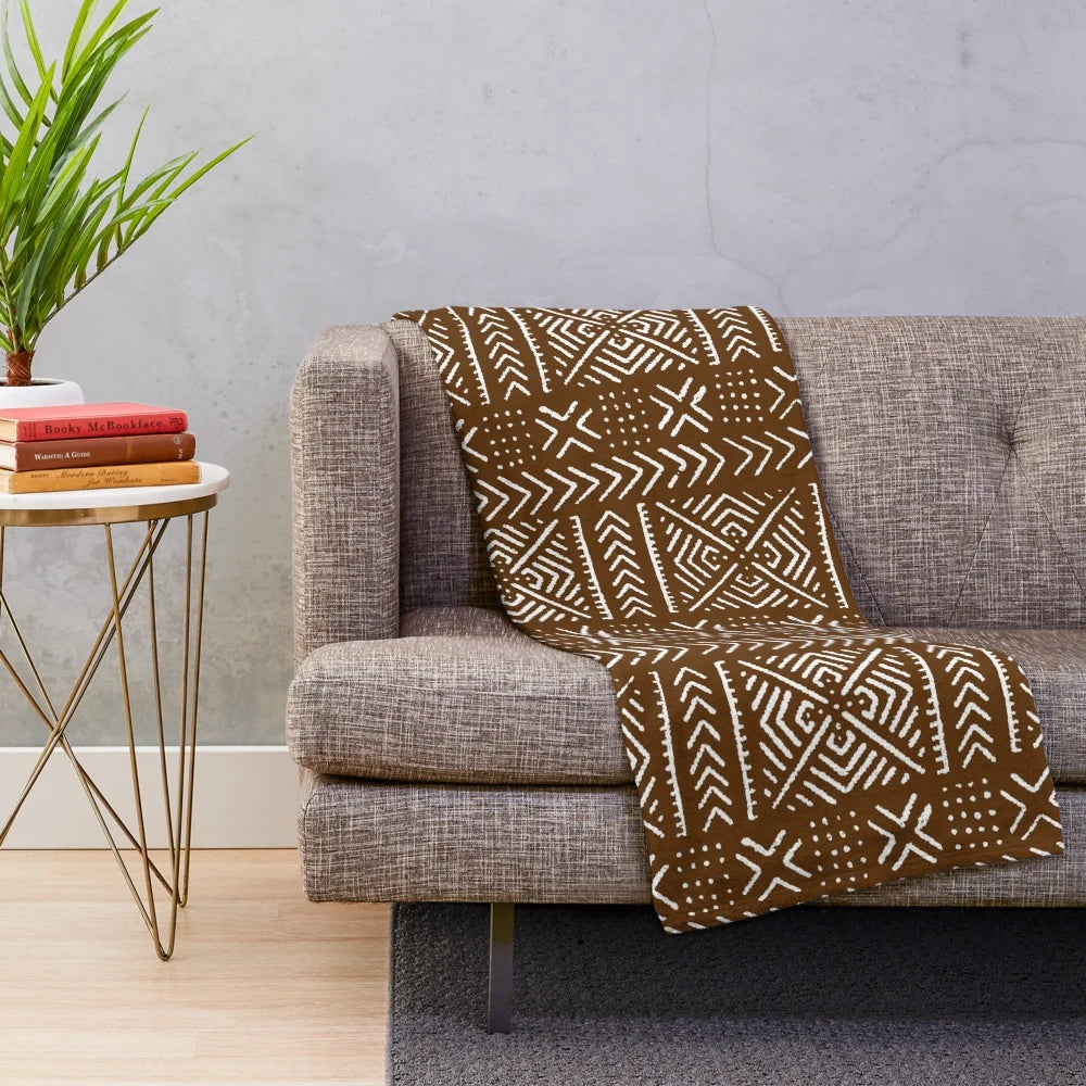 Brown plush blanket with intricate African mud cloth design