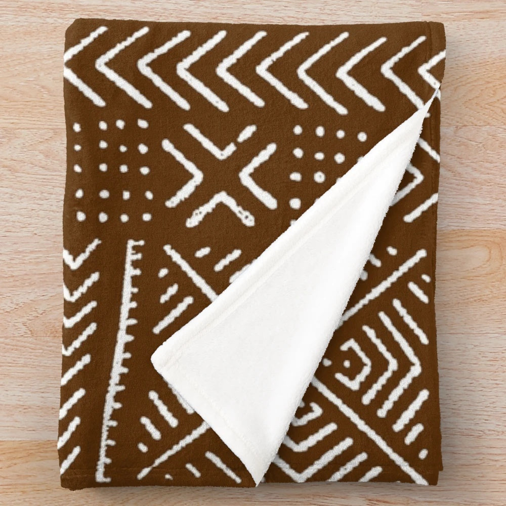 Brown plush blanket with intricate African mud cloth design