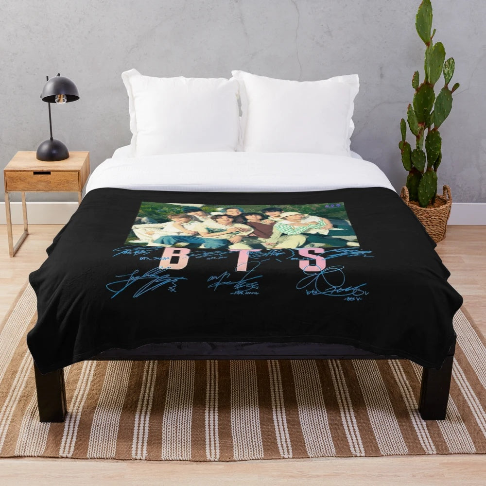 BTS-inspired plush blanket with group members' names and symbols