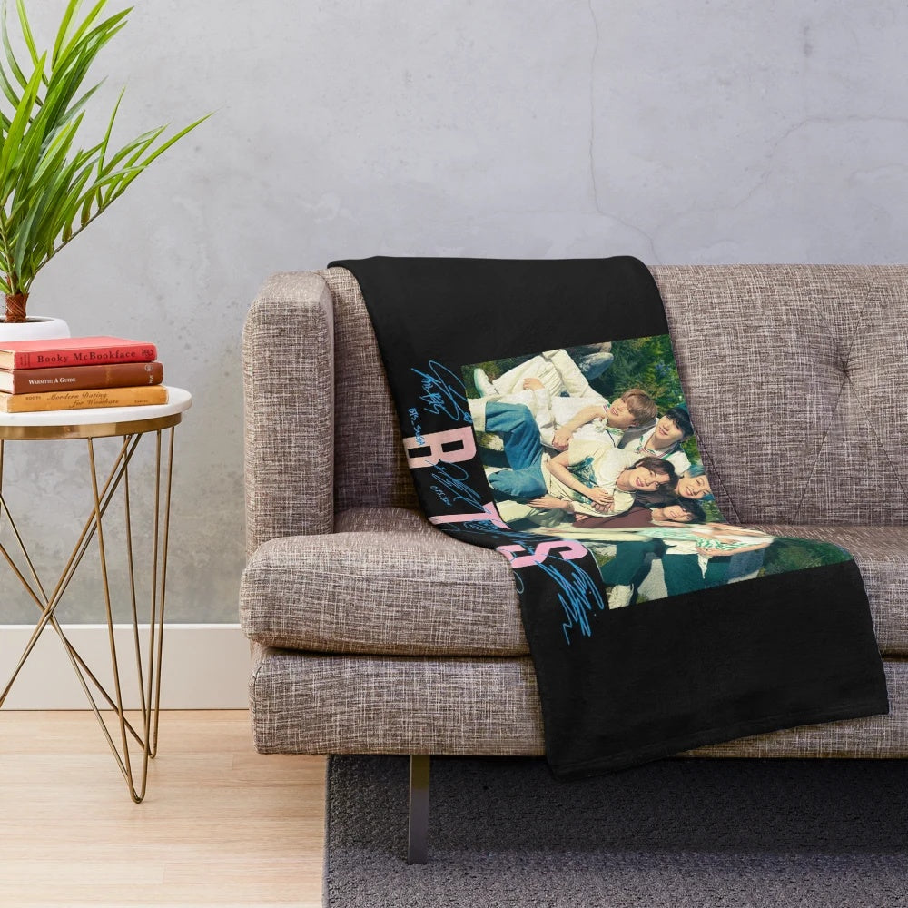 BTS-inspired plush blanket with group members' names and symbols