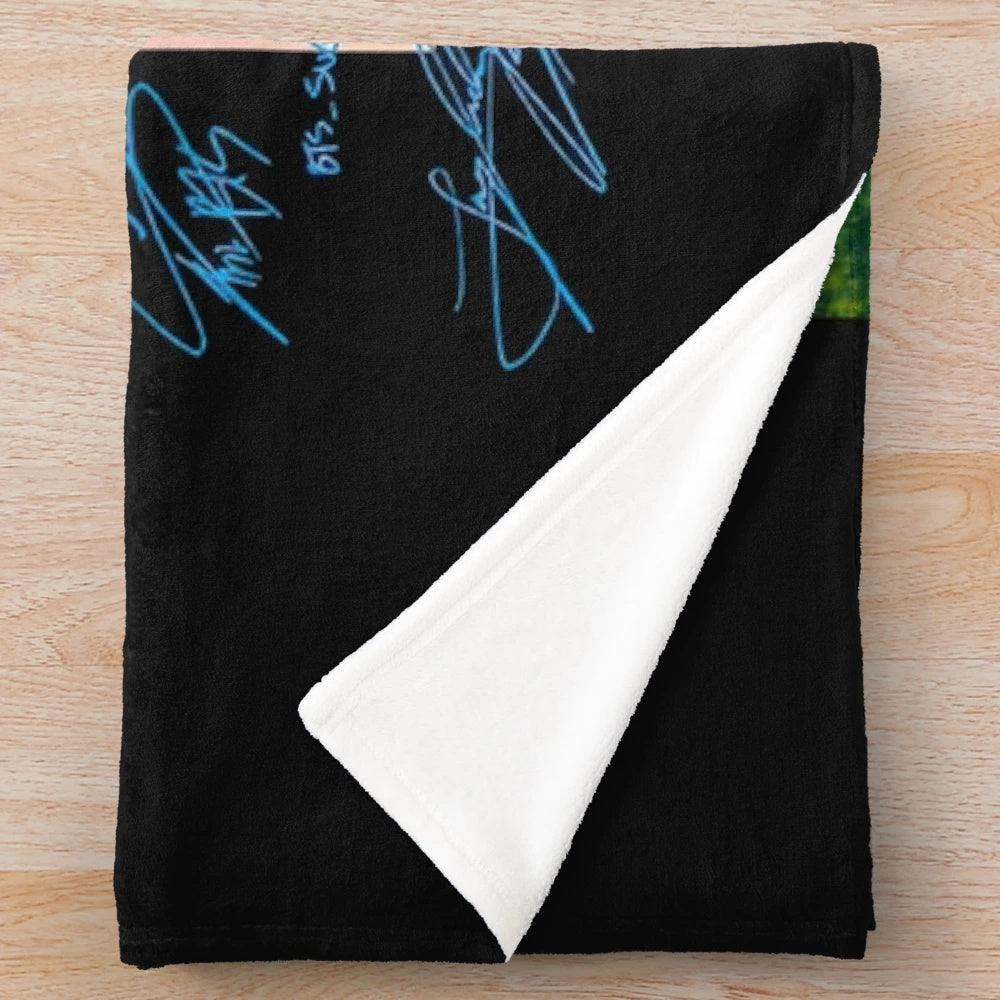 BTS-inspired plush blanket with group members' names and symbols