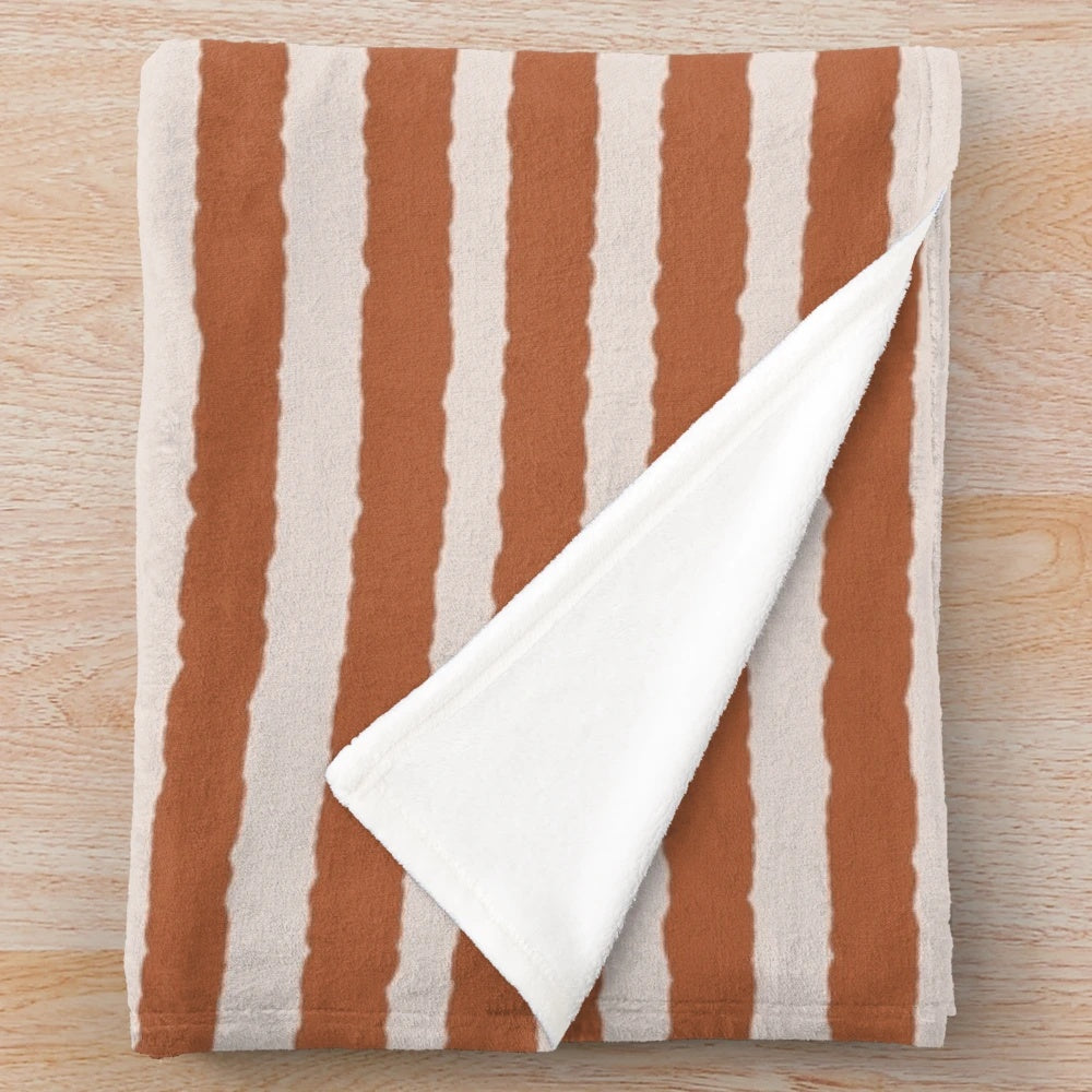 Burnt orange and cream striped plush blanket