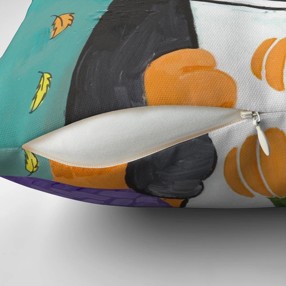 A calico cat wearing glasses and holding a coffee cup, sitting on an autumn-themed pillow