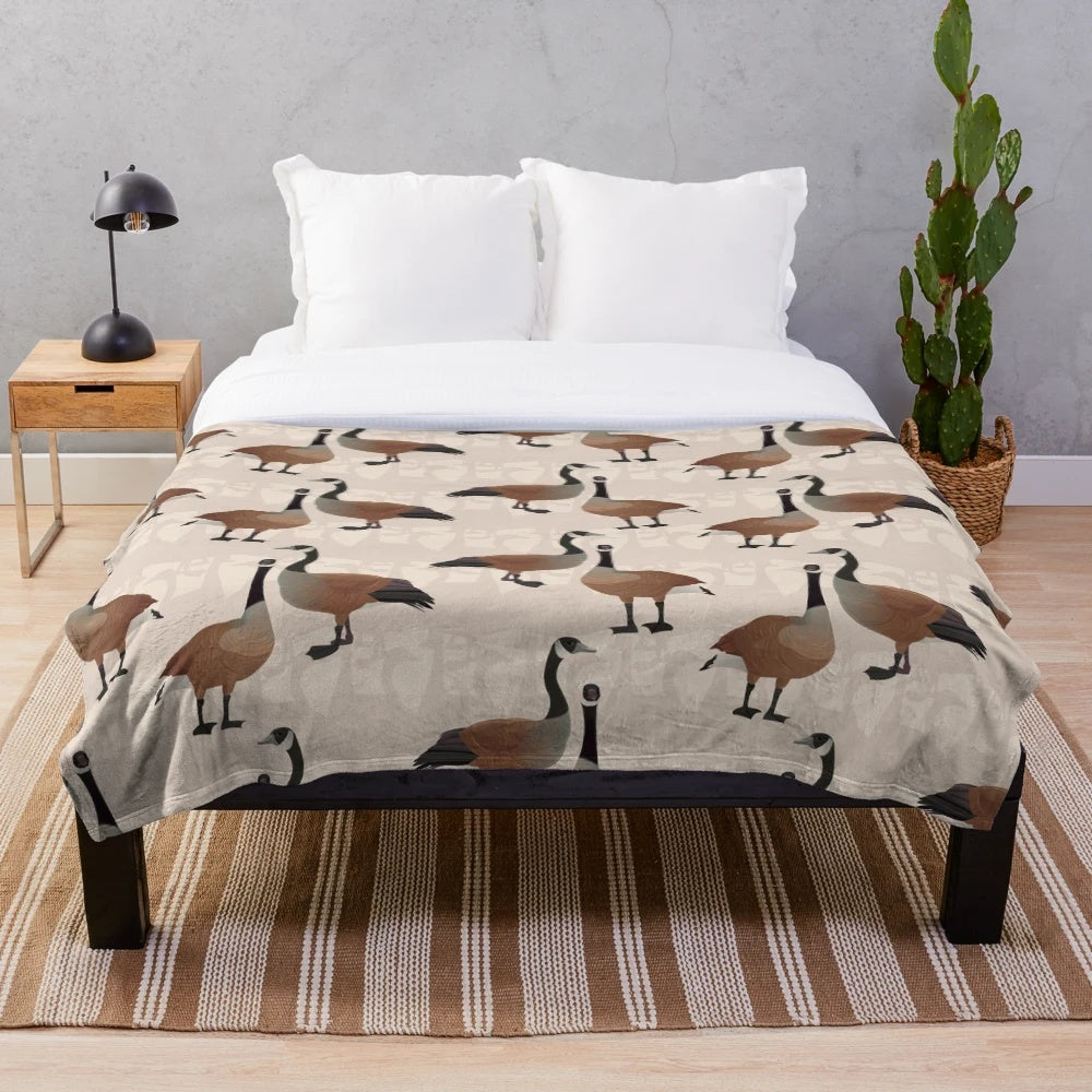 Canada Goose plush blanket with maple leaf and Canadian wildlife design