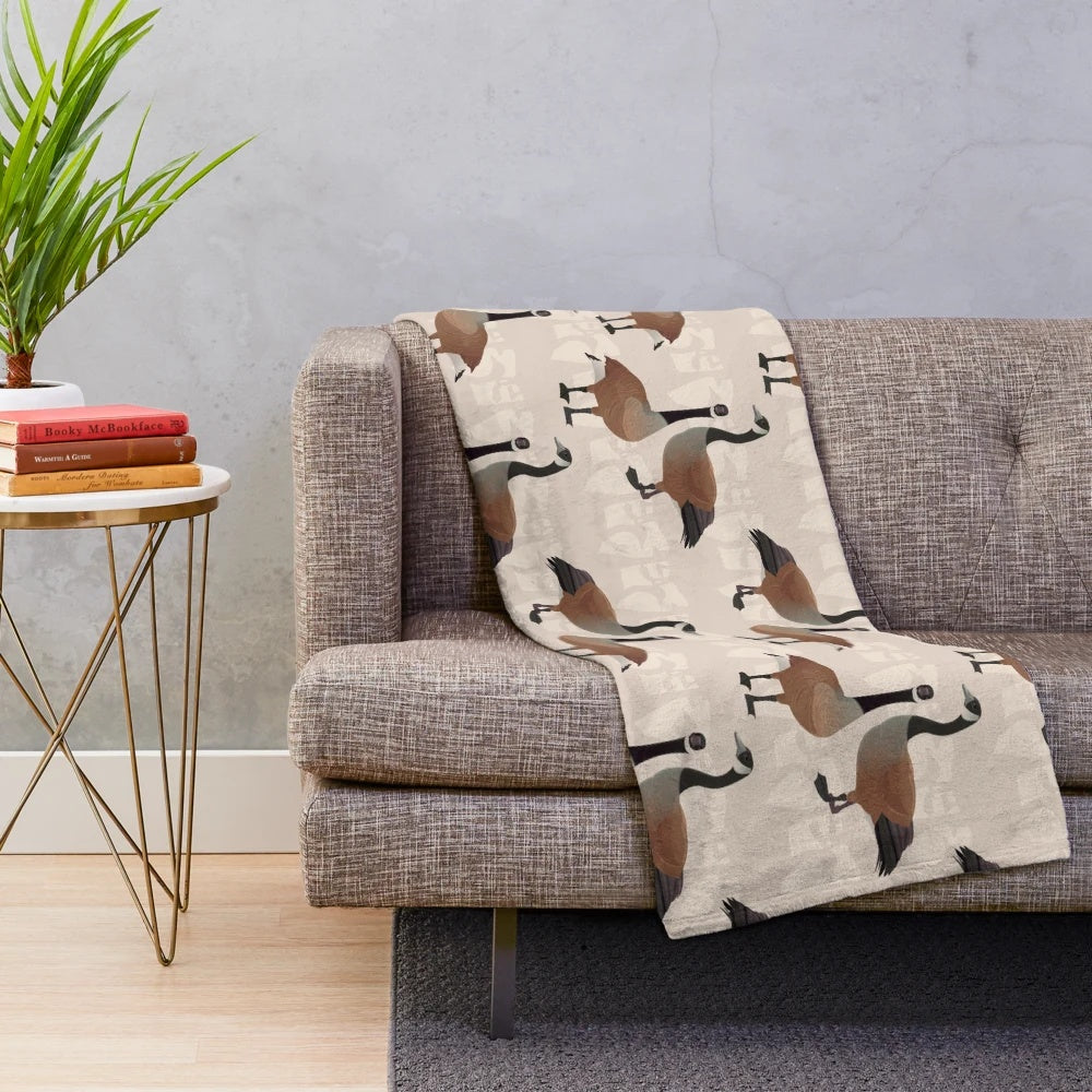 Canada Goose plush blanket with maple leaf and Canadian wildlife design