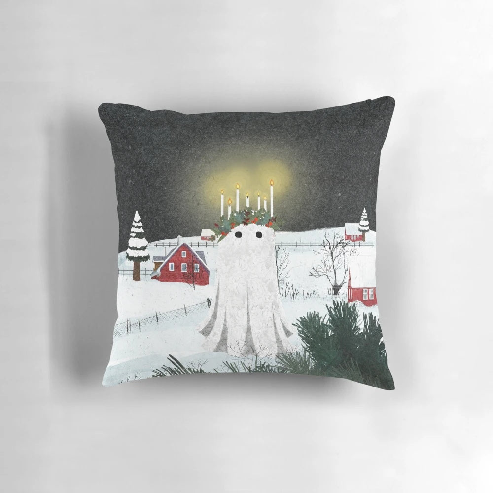 A fluffy white pillow with a charming candlelight design, perfect for a cozy winter home.