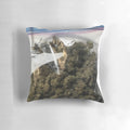 A plush, zippered pillow featuring a stylized cannabis leaf design