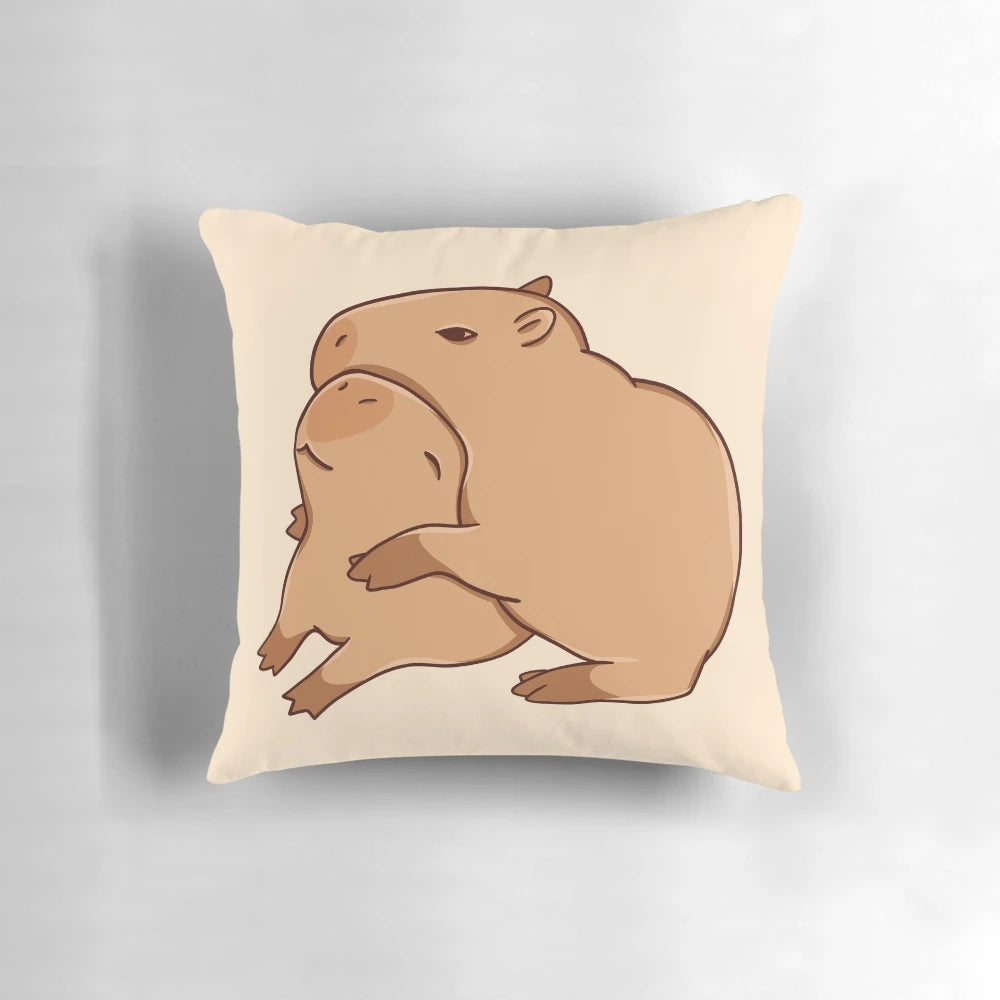A soft, plush pillow featuring a cute, cartoon-style capybara in a comforting hugging pose.