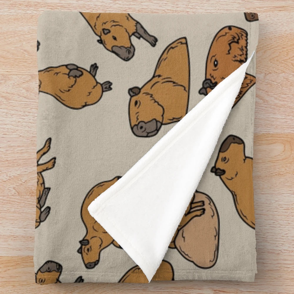 Cozy capybara plush blanket featuring a cute, repeating pattern of the lovable South American rodent