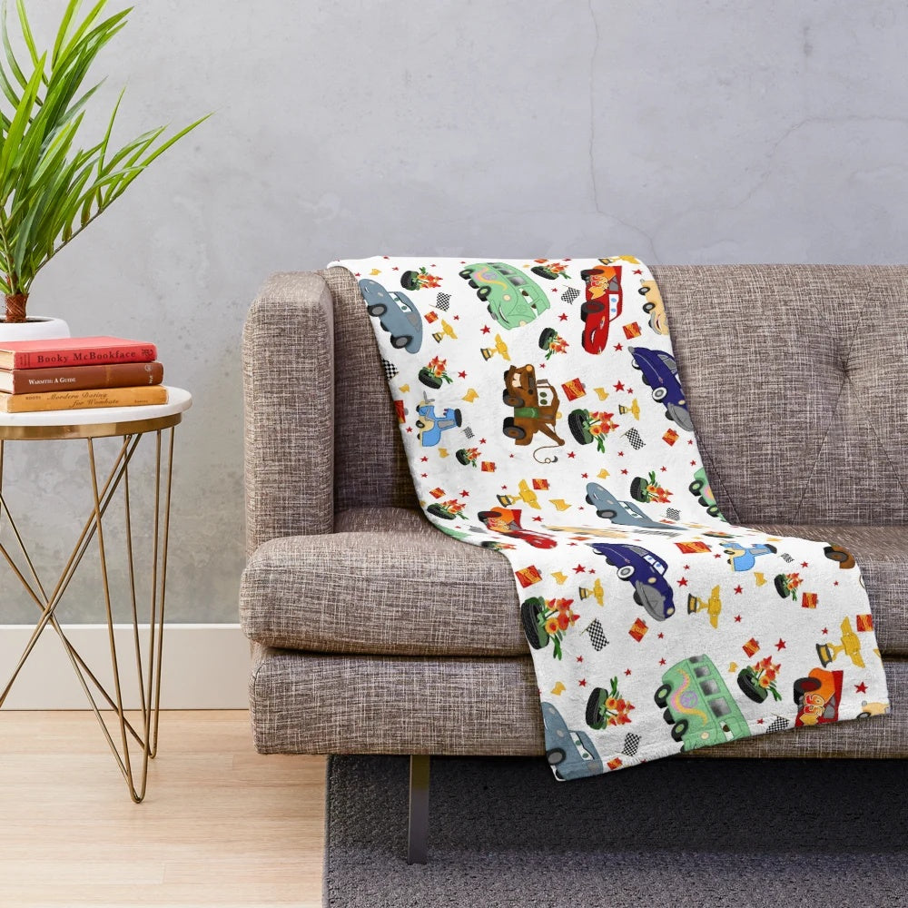 Plush blanket with Cars movie characters like Lightning McQueen, Mater, and Sally