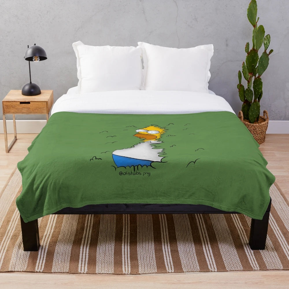 Homer Simpson cartoon character peeking out from bushes on a plush blanket