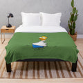Homer Simpson cartoon character peeking out from bushes on a plush blanket