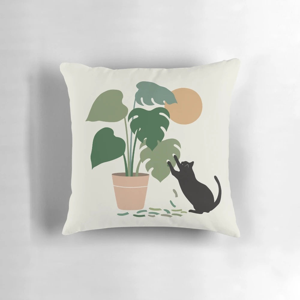 Decorative throw pillow with a black cat and lush monstera leaves pattern