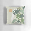 A cozy pillow featuring a cat resting next to a lush, green plant in a nature-inspired setting