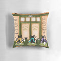 Whimsical black cat pillow featuring a cozy café scene, perfect for cat lovers and coffee enthusiasts.