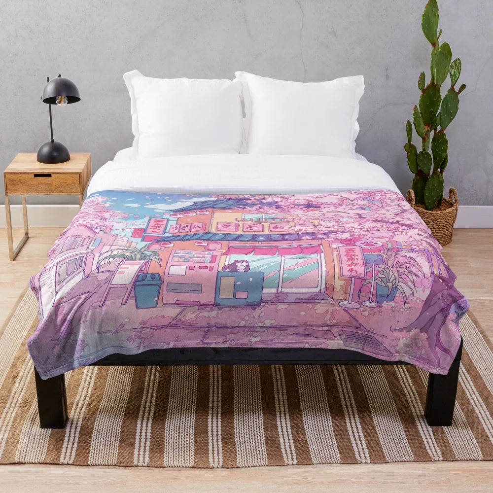 Soft and snuggly plush blanket featuring a cute cat surrounded by pink sakura blossoms
