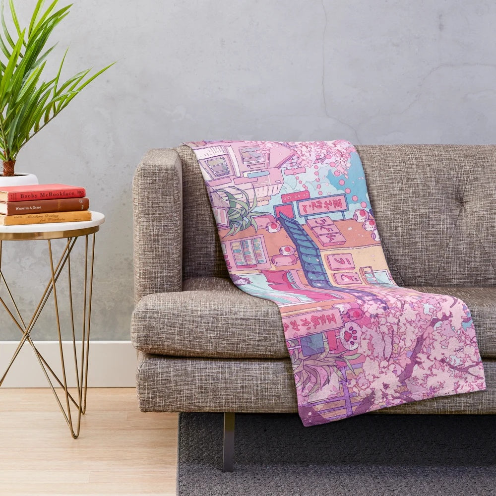 Soft and snuggly plush blanket featuring a cute cat surrounded by pink sakura blossoms
