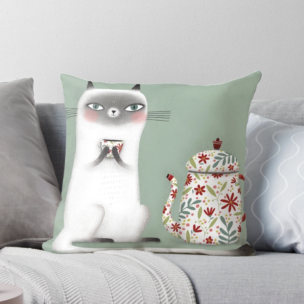 A cozy Siamese cat pillow design featuring a cute cat drinking a hot beverage.