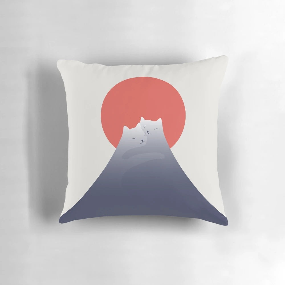 A plush pillow featuring a minimalist illustration of a cat sitting atop a mountain with a beautiful sunset landscape.