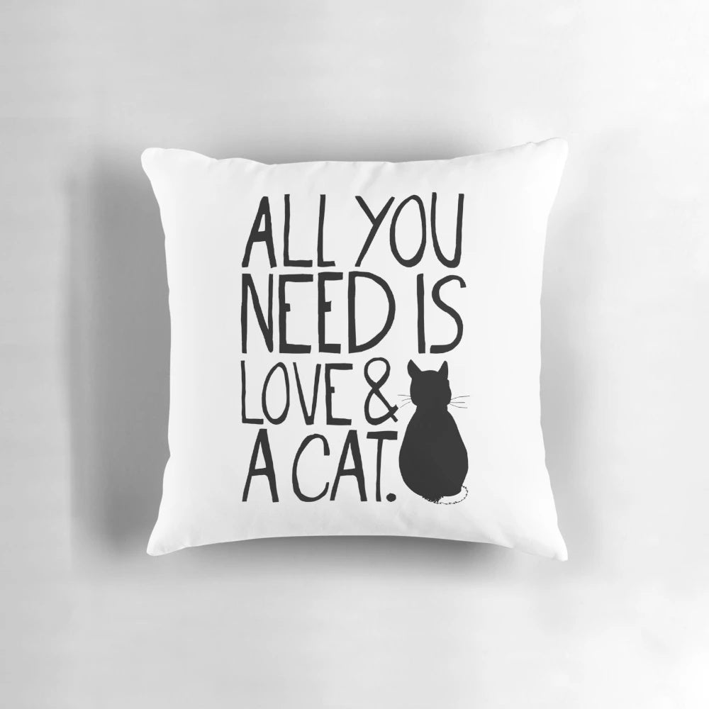 Soft, plush pillow with the text "All You Need Is Love and A Cat" printed on it