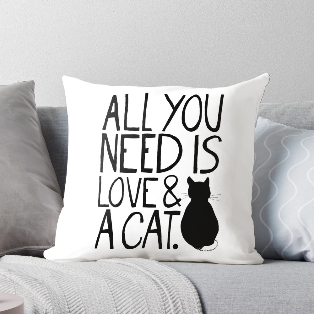 Soft, plush pillow with the text "All You Need Is Love and A Cat" printed on it