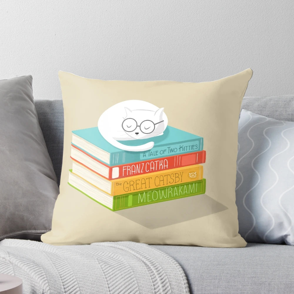 A decorative cat-themed pillow with a whimsical book and literature design.