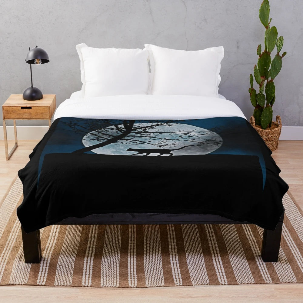 A cozy plush blanket featuring a cat silhouette in front of a full moon