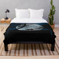 A cozy plush blanket featuring a cat silhouette in front of a full moon
