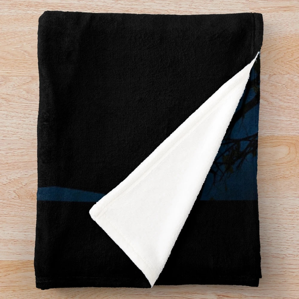 A cozy plush blanket featuring a cat silhouette in front of a full moon