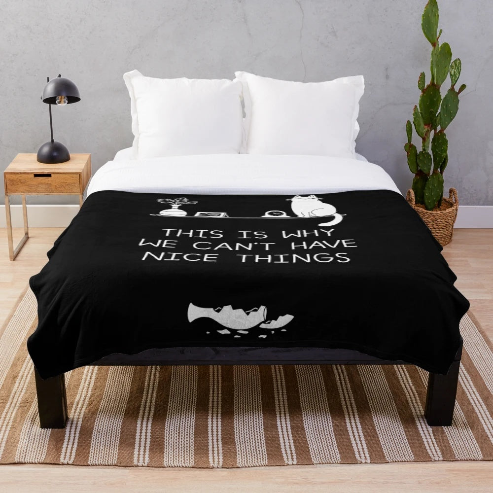 Plush blanket with "This is Why We Can't Have Nice Things" typography and cat-related imagery