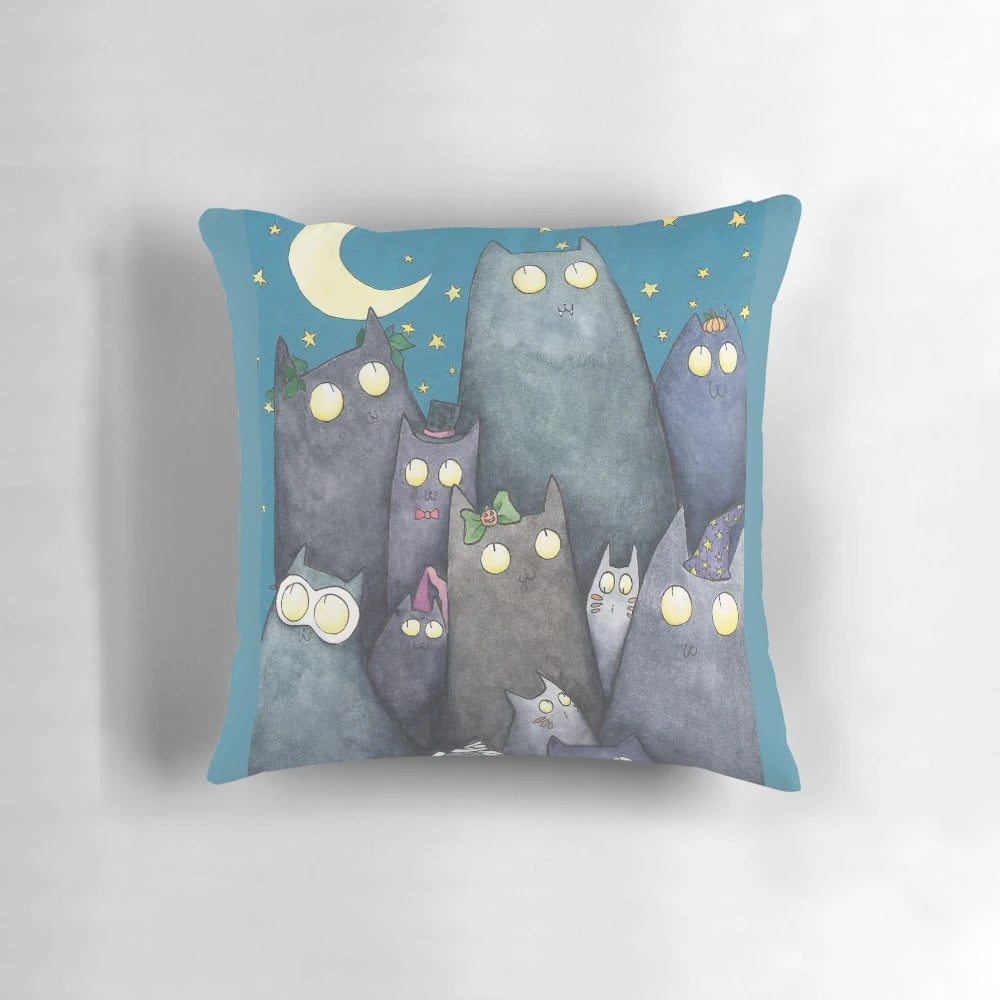 A soft, decorative pillow featuring a colorful design of cats, moons, and stars, perfect for adding a touch of feline fun to your home.