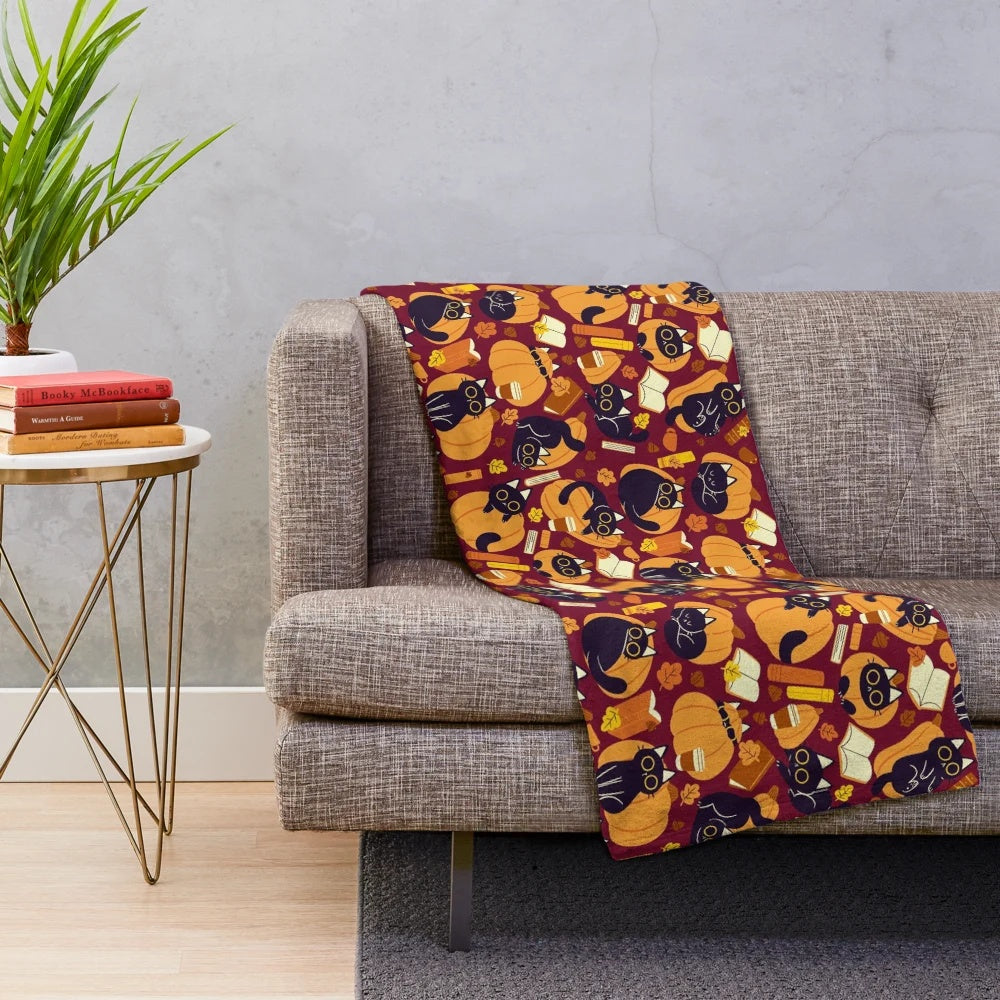 Plush blanket with cats, pumpkins and books pattern