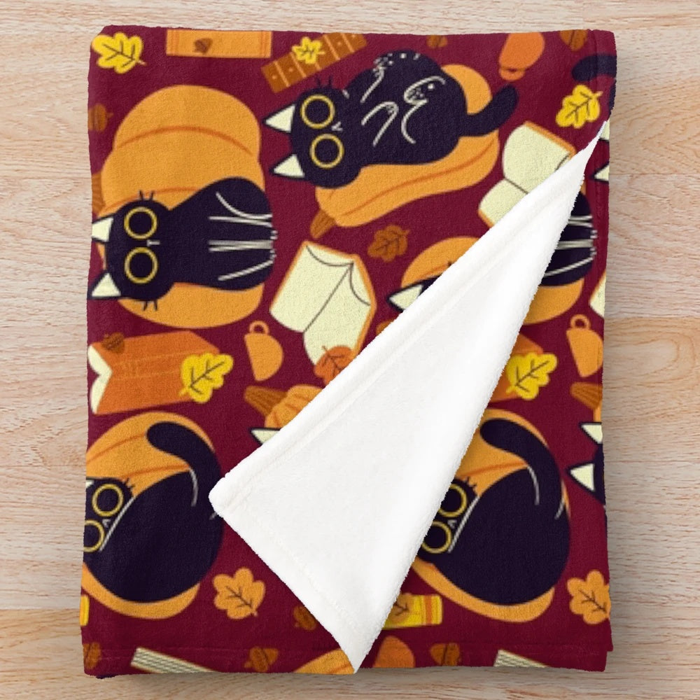Plush blanket with cats, pumpkins and books pattern