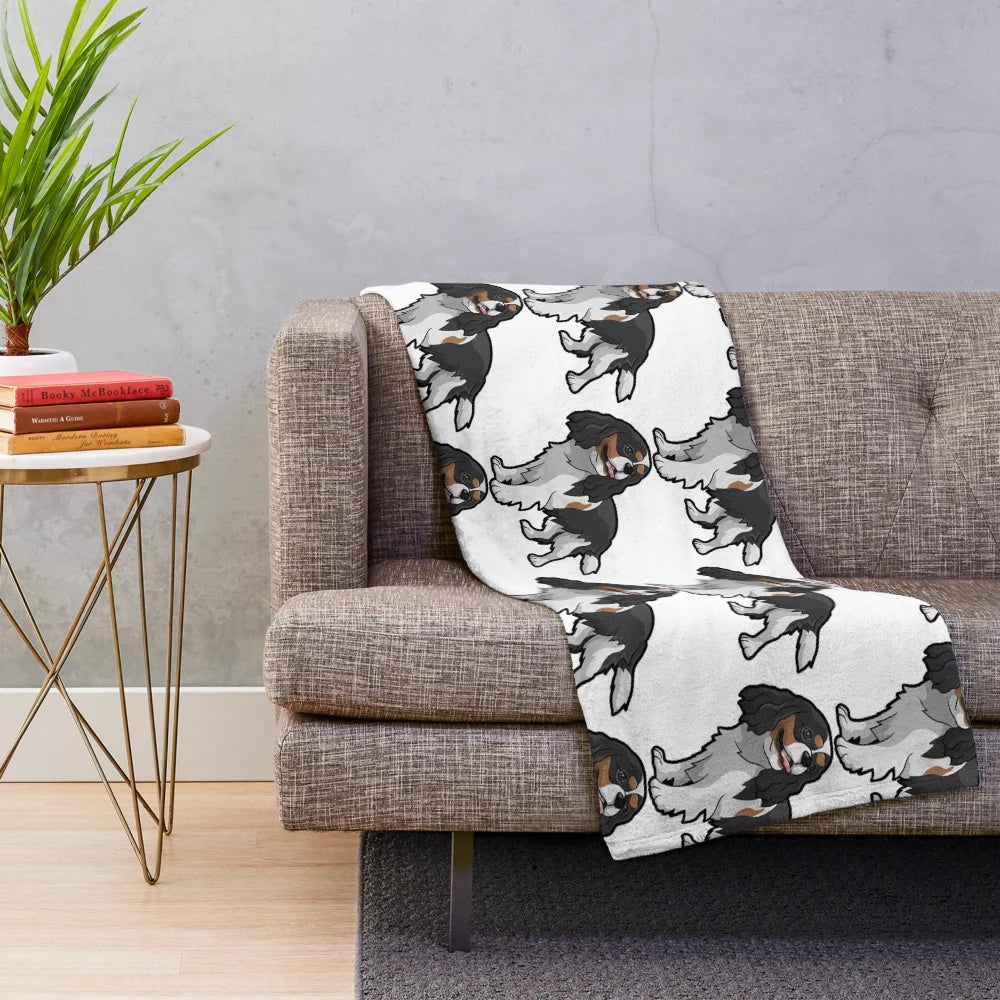 Cavalier King Charles Spaniel curled up on a soft, plush blanket