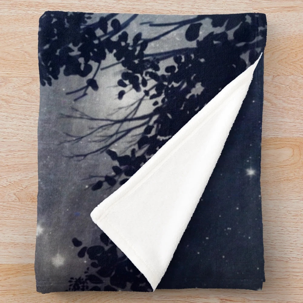 Plush blanket featuring a night sky design with planets and stars