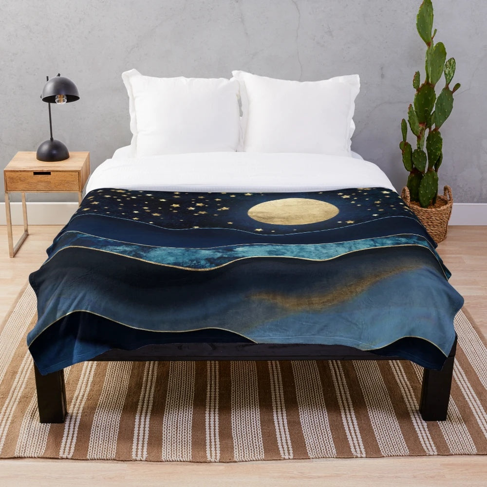 Cozy plush blanket with golden moon and starry night design