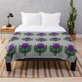 Soft, plush blanket featuring a beautiful celtic thistle floral pattern in green and purple colors
