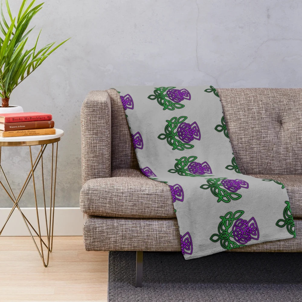 Soft, plush blanket featuring a beautiful celtic thistle floral pattern in green and purple colors