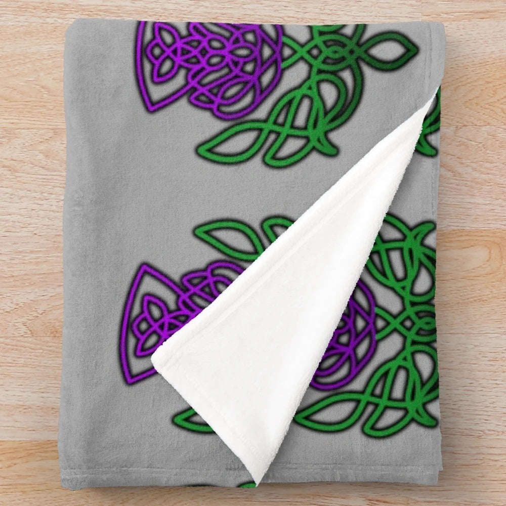 Soft, plush blanket featuring a beautiful celtic thistle floral pattern in green and purple colors