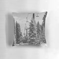 A cozy, decorative pillow featuring a scenic chairlift ascending a snowy mountain landscape.