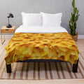 Cozy cheesy plush blanket featuring macaroni and cheese design