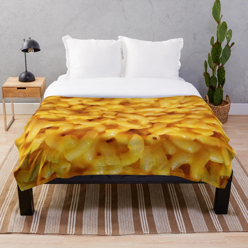 Cozy cheesy plush blanket featuring macaroni and cheese design