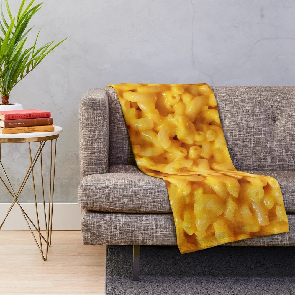 Cozy cheesy plush blanket featuring macaroni and cheese design
