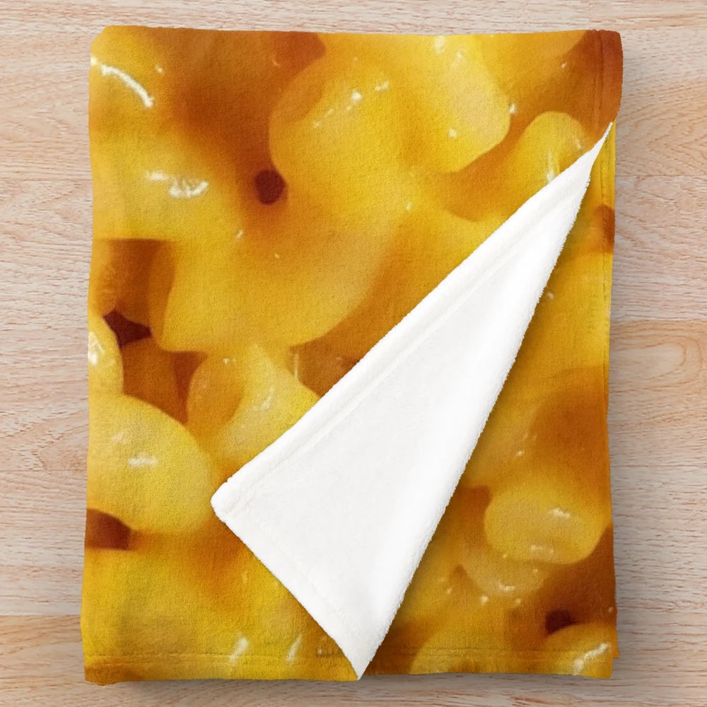 Cozy cheesy plush blanket featuring macaroni and cheese design